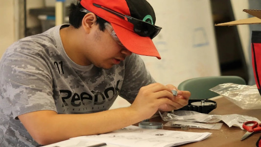 Student working on a gear assembly